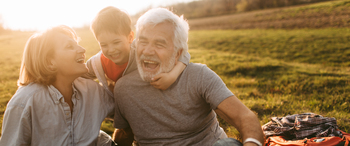 Photo of a little boy and his grandparents having a picnic outdoors, in the nature // wide photo dimensions